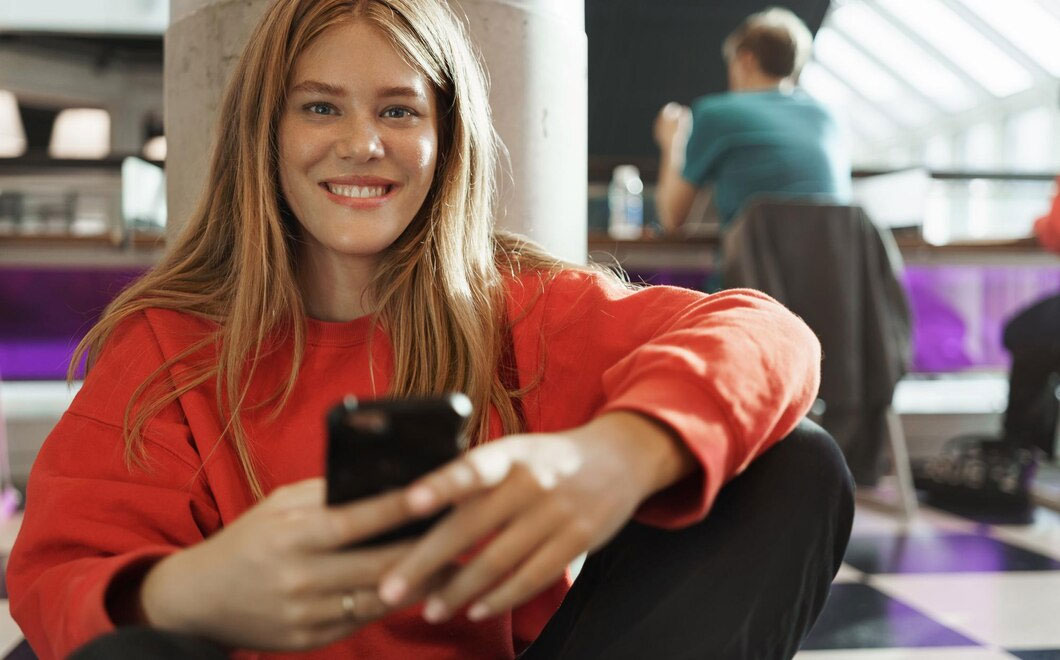 student smiling happy girl sitting using mobile phone